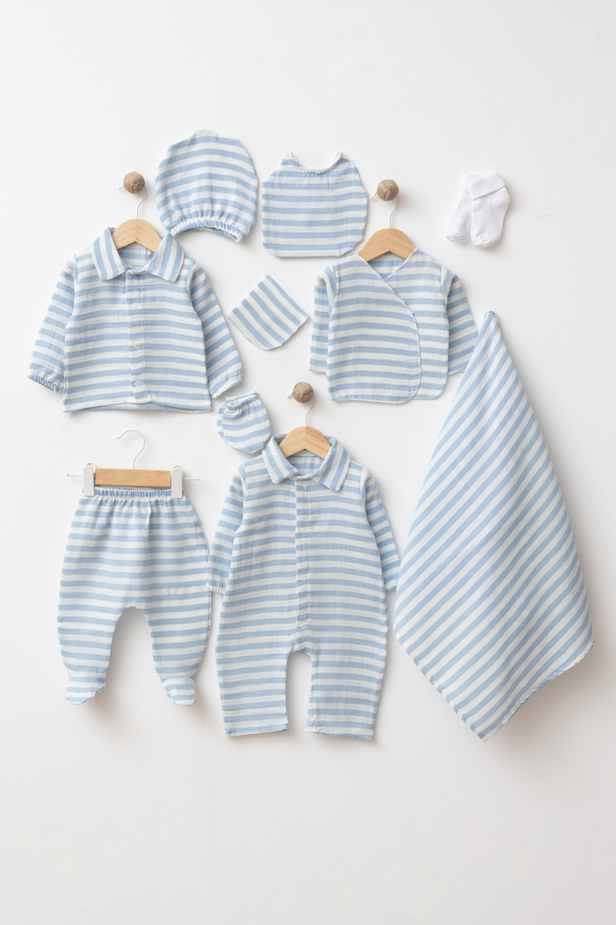 Wholesale 10-piece baby boy hospital set made from 100% cotton GOTS certified fabric including coordinated striped newborn clothing, blanket, hat, bib, mittens and socks.