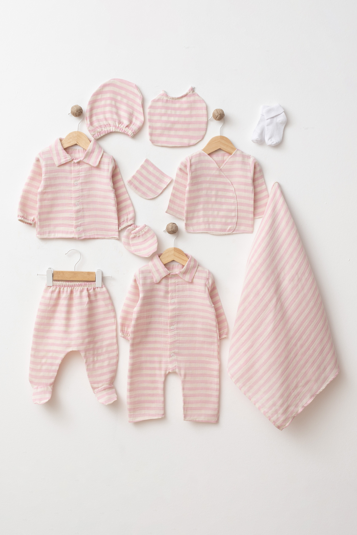 Wholesale 10-piece GOTS-certified 100% cotton baby girl hospital set with coordinated newborn clothing, blanket, hat, bib, mittens and socks.