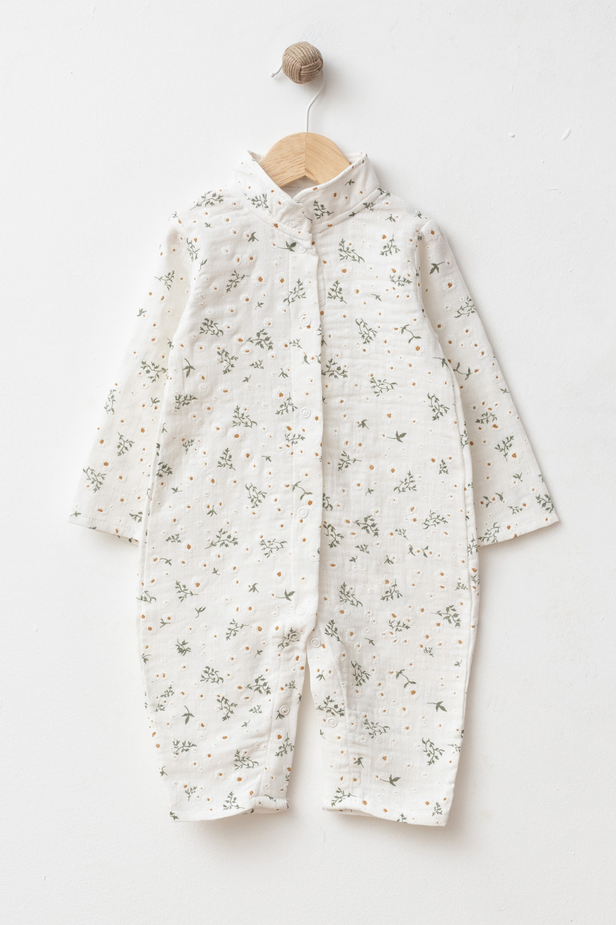Wholesale GOTS-certified cotton long-sleeve baby romper with nature-inspired print and snap-button closure, available in a 4-piece size set for 3, 6, 9 and 12 months.