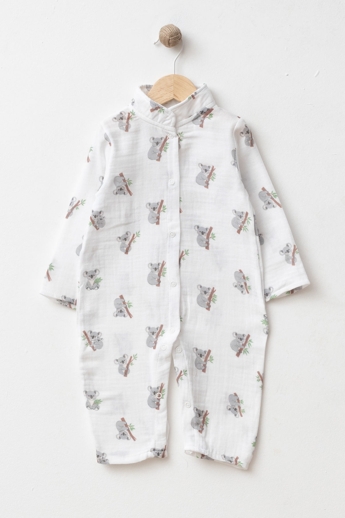 Wholesale GOTS-certified 100% cotton koala print long-sleeve baby romper with snap-button closure, supplied in a 4-piece size set for 3, 6, 9 and 12 months.